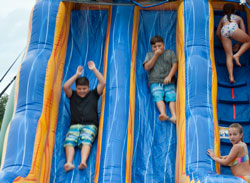 2 boys and 2 girls on the inflatable water slide